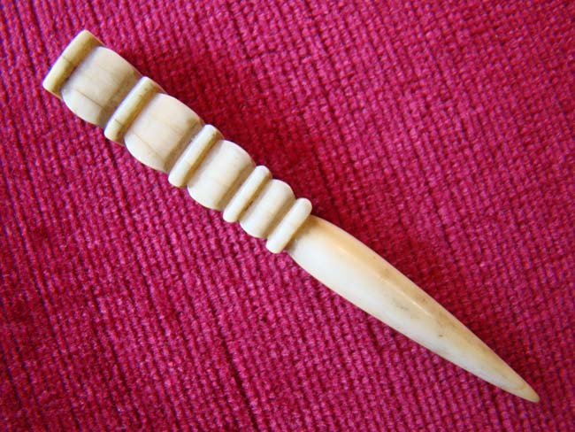 A very nice 19th century sailor-made whale ivory bodkin with squared tiered knob.